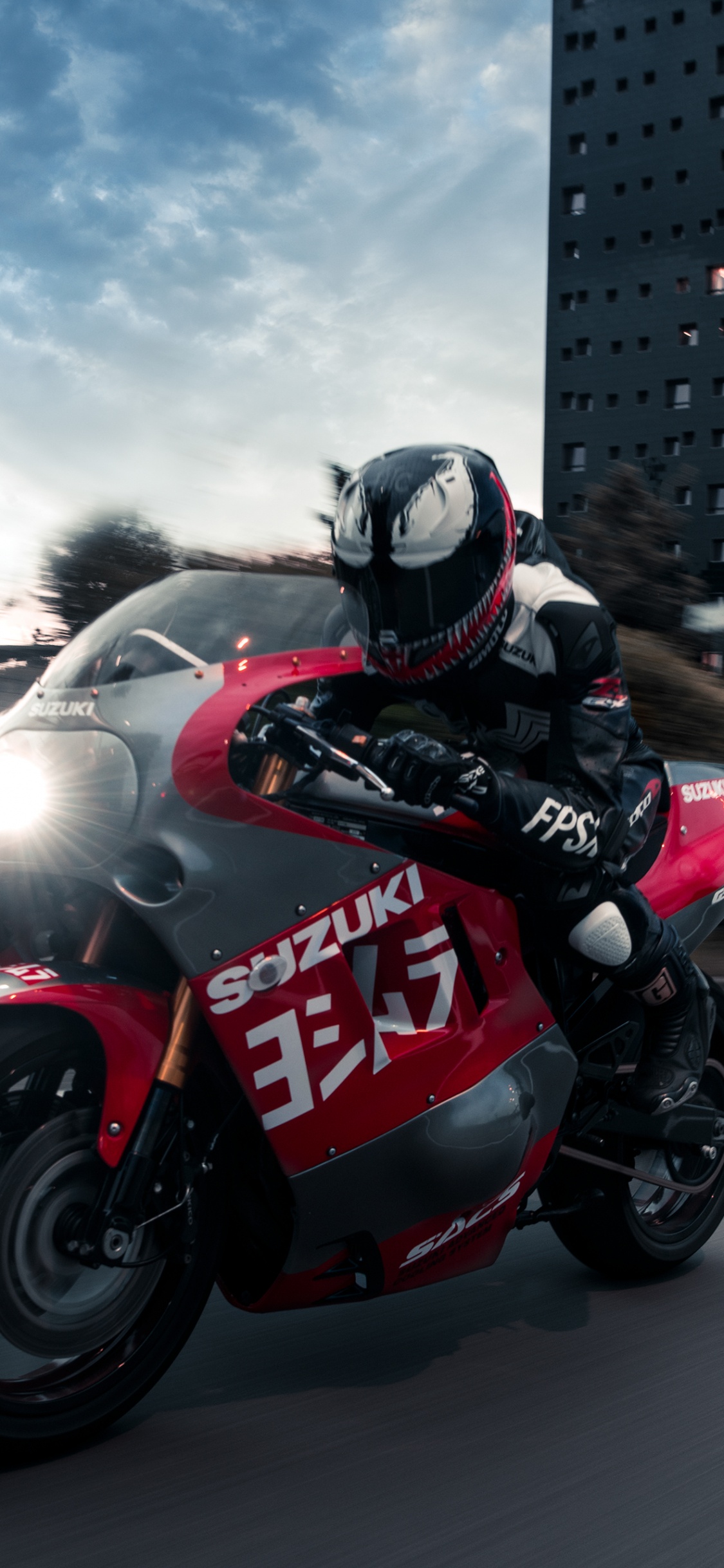 Hombre en Casco de Motocicleta Negro y Rojo Montando Bicicleta Deportiva Roja y Negra. Wallpaper in 1125x2436 Resolution