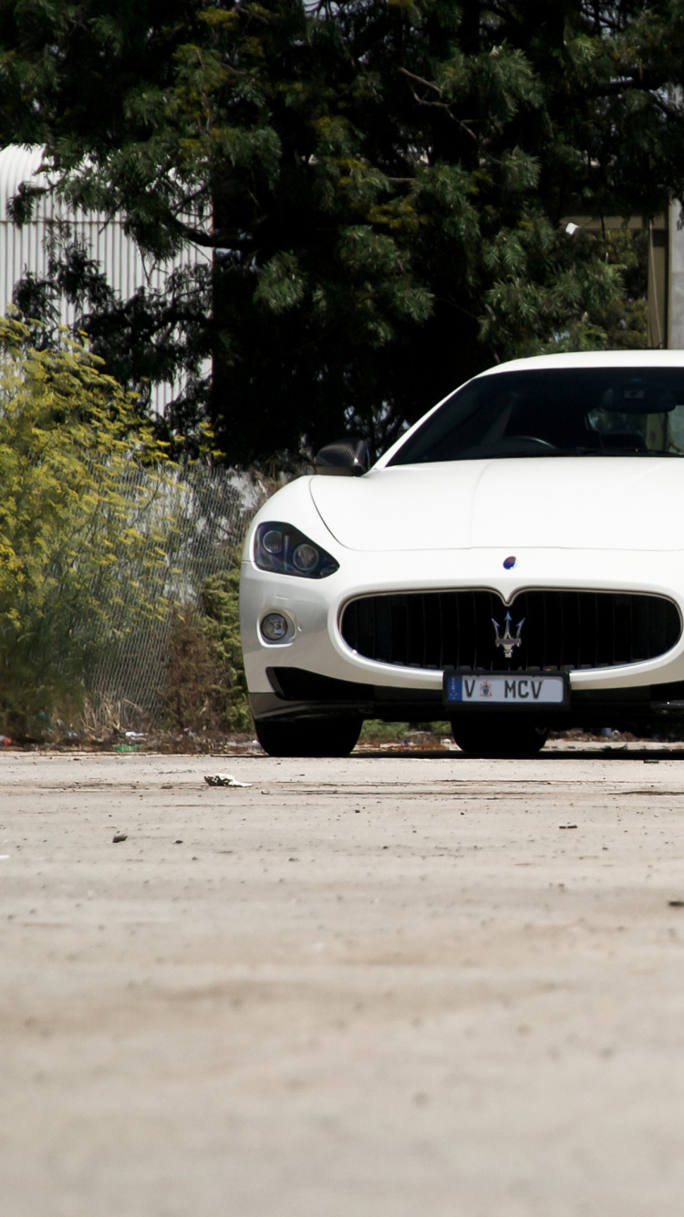 White Porsche 911 Parked Near Building During Daytime. Wallpaper in 750x1334 Resolution