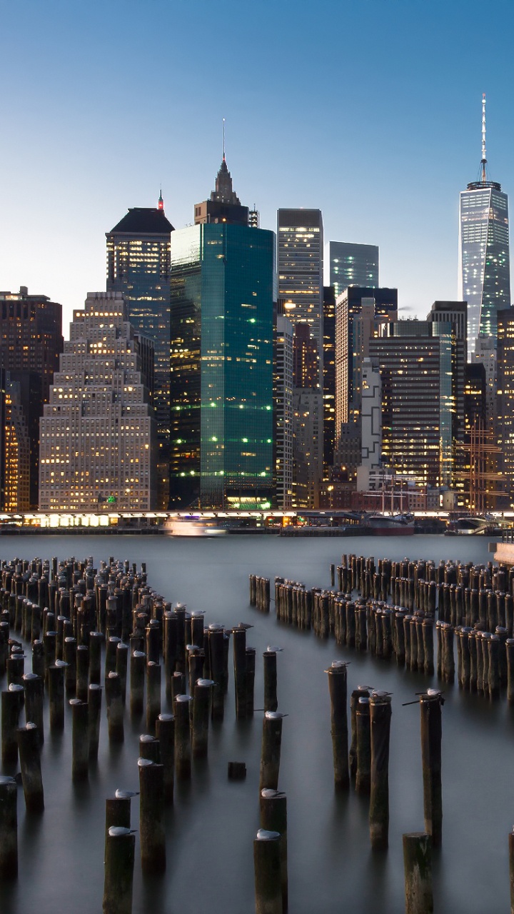 City Skyline Across Body of Water During Night Time. Wallpaper in 720x1280 Resolution