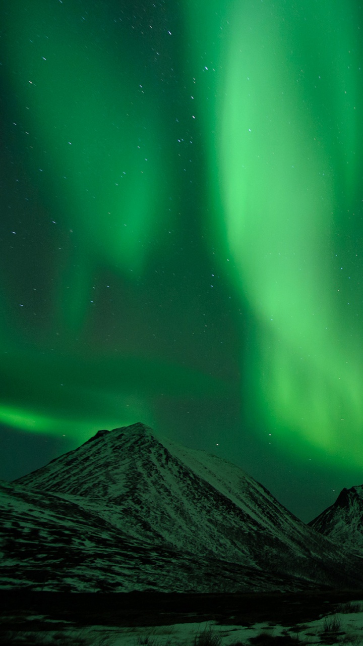 Green Aurora Lights Over Black and White Mountain. Wallpaper in 720x1280 Resolution
