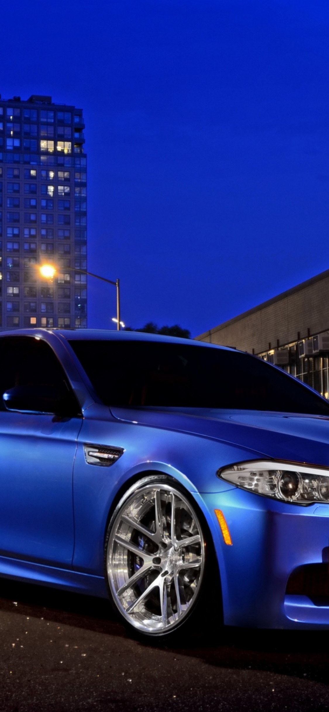 Blue Bmw m 3 Coupe Parked on Parking Lot During Night Time. Wallpaper in 1125x2436 Resolution
