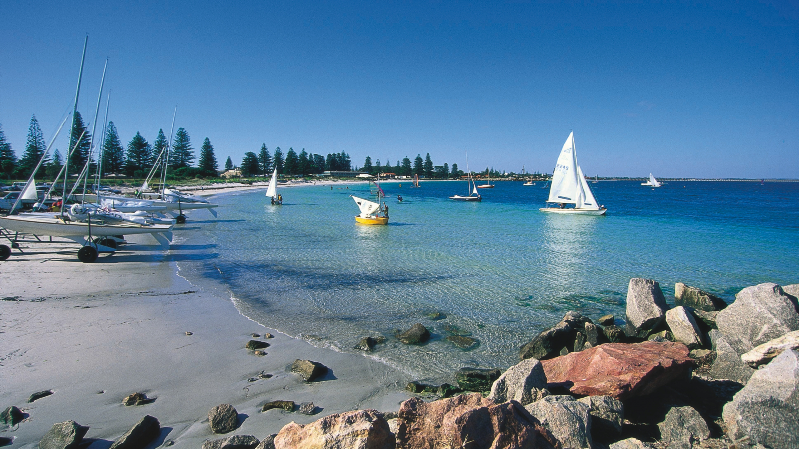 White Sail Boat on Sea Shore During Daytime. Wallpaper in 2560x1440 Resolution