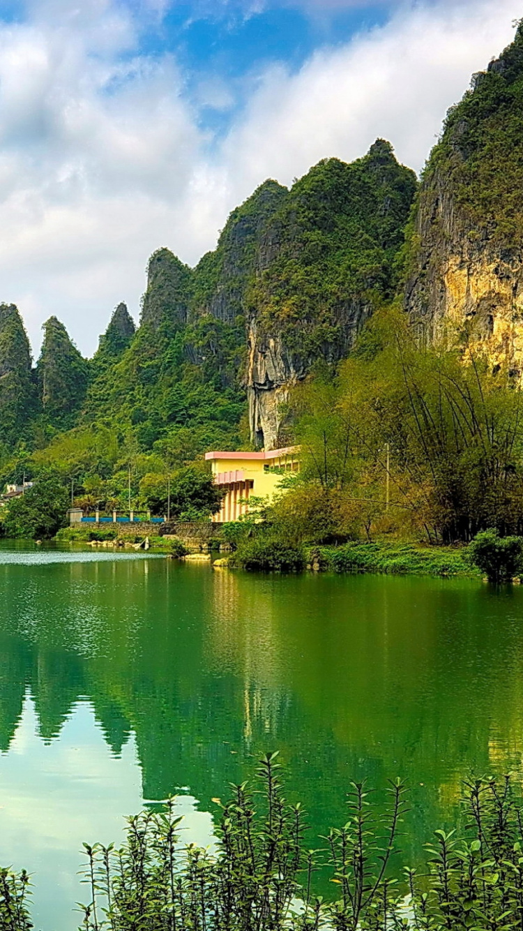 Green Trees Near Lake Under Blue Sky During Daytime. Wallpaper in 750x1334 Resolution
