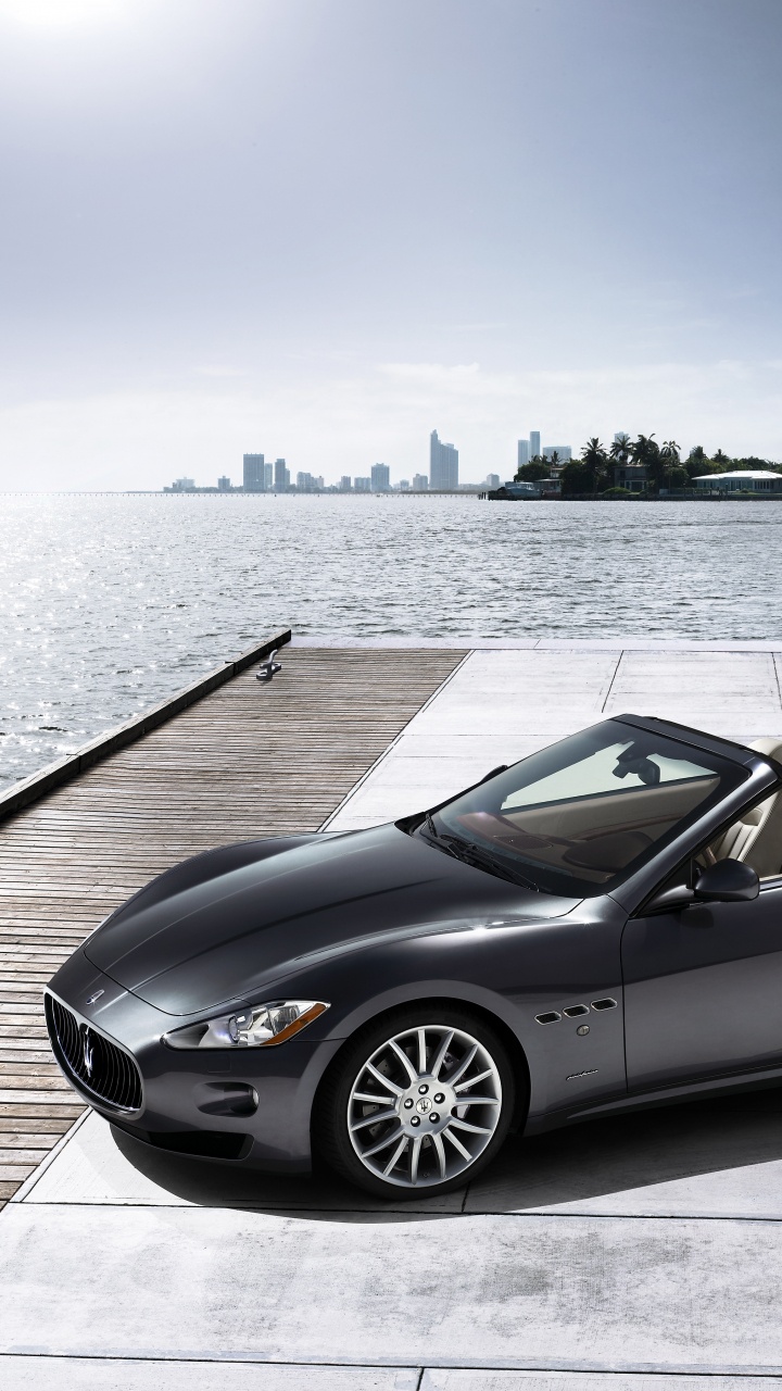 Black Convertible Coupe Parked on Dock During Daytime. Wallpaper in 720x1280 Resolution