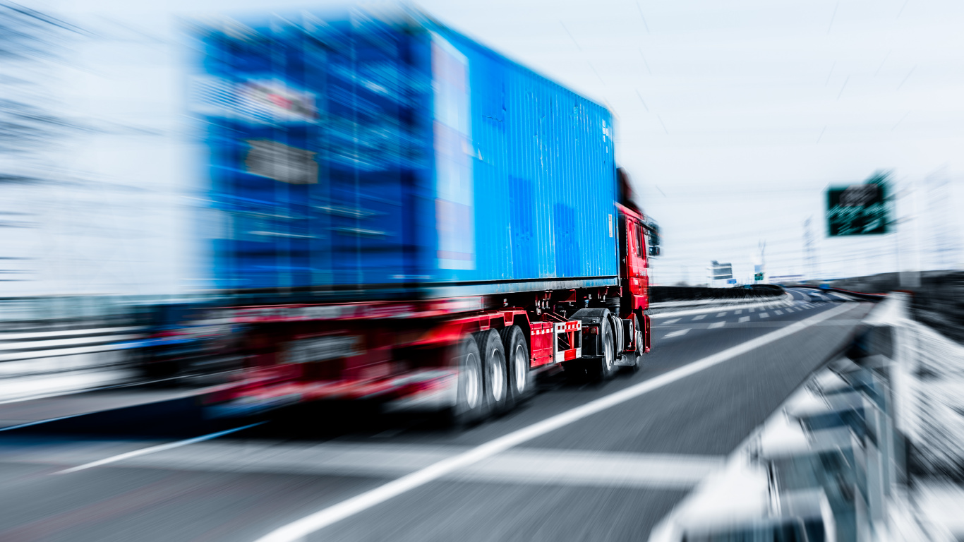 Blue and Red Freight Truck on Road During Daytime. Wallpaper in 1366x768 Resolution
