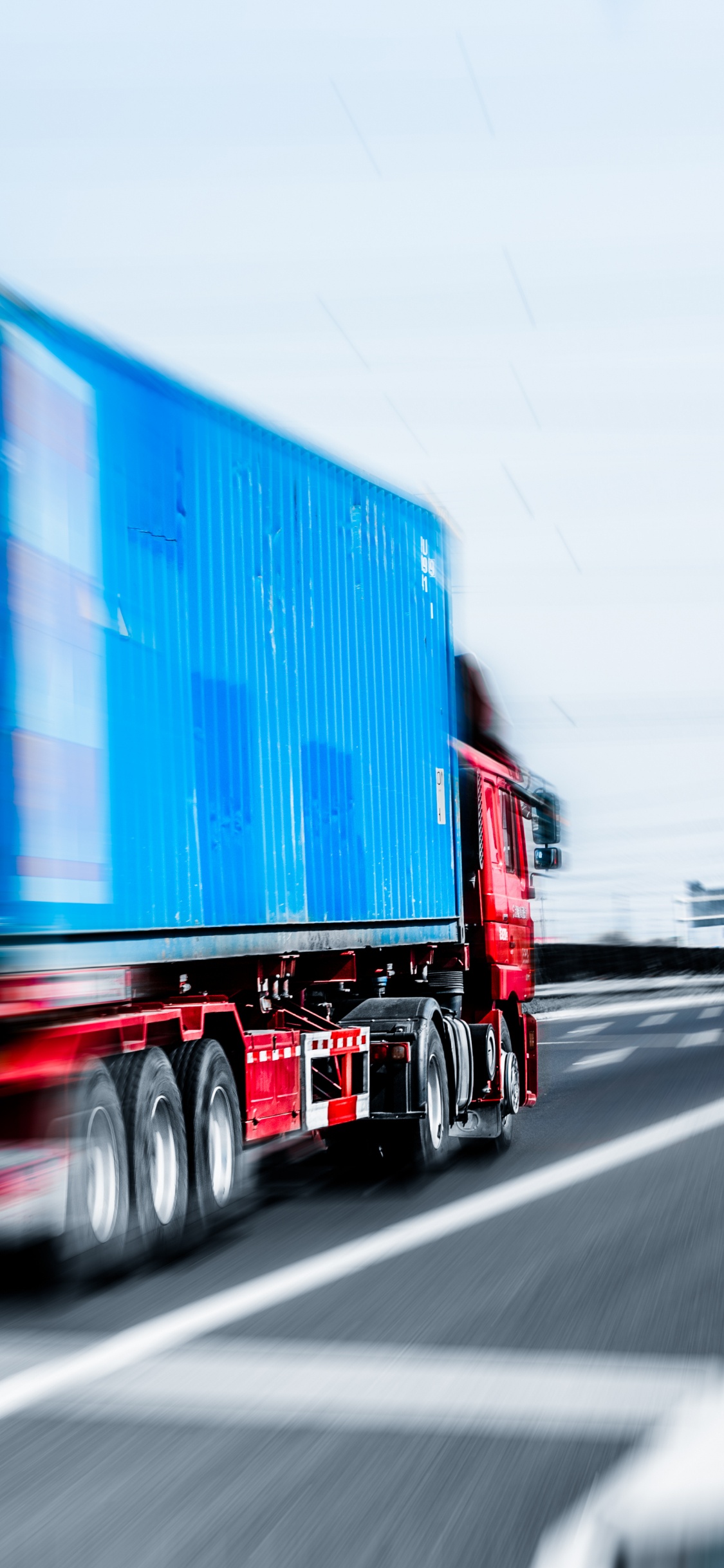 Camion de Fret Bleu et Rouge Sur la Route Pendant la Journée. Wallpaper in 1125x2436 Resolution