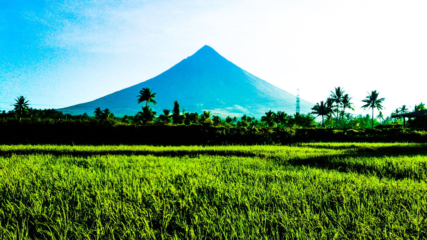 Green Grass Field Near Mountain Under White Clouds During Daytime. Wallpaper in 1366x768 Resolution