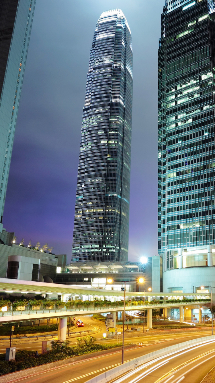 Cars on Road Near High Rise Buildings During Night Time. Wallpaper in 750x1334 Resolution