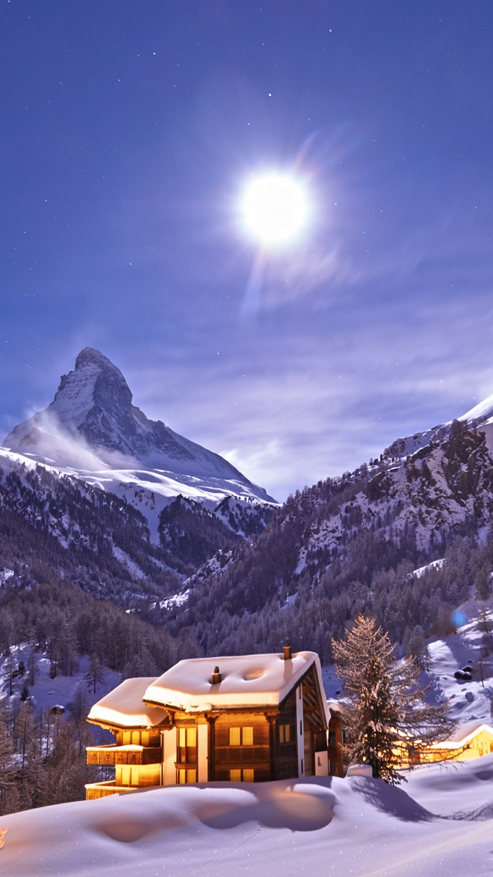 Brown House on Snow Covered Ground Near Snow Covered Mountain During Daytime. Wallpaper in 720x1280 Resolution