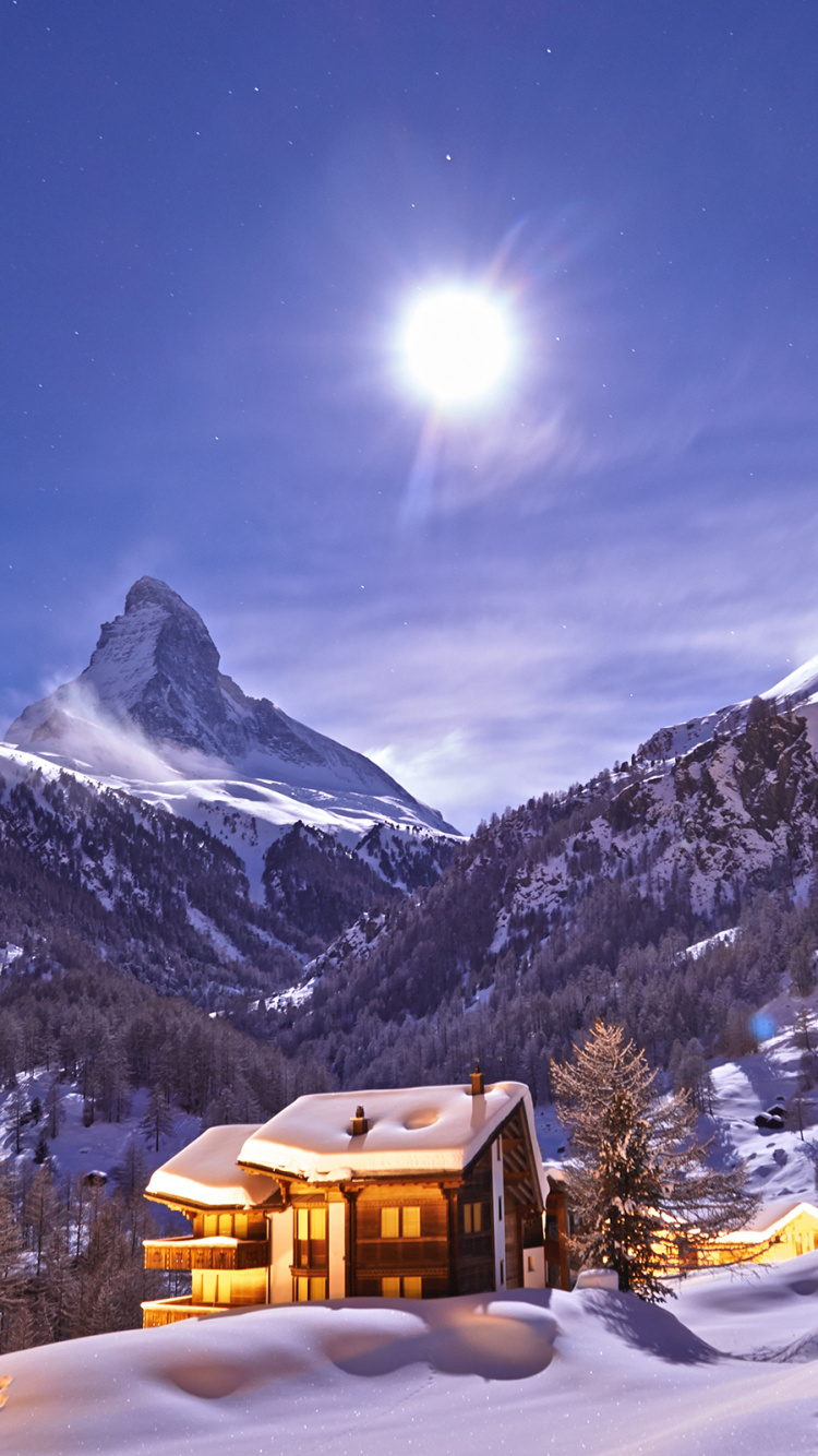 Brown House on Snow Covered Ground Near Snow Covered Mountain During Daytime. Wallpaper in 750x1334 Resolution