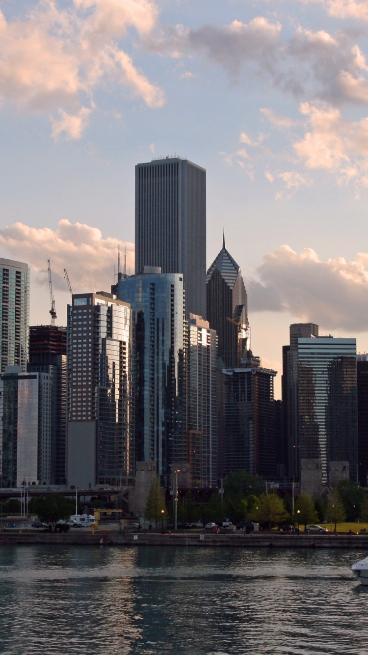 White Boat on Water Near City Buildings During Daytime. Wallpaper in 750x1334 Resolution
