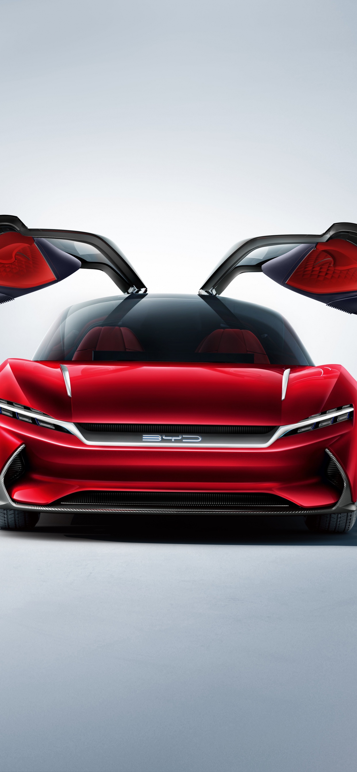 Roter Ferrari-sportwagen Auf Grauem Pflaster. Wallpaper in 1242x2688 Resolution