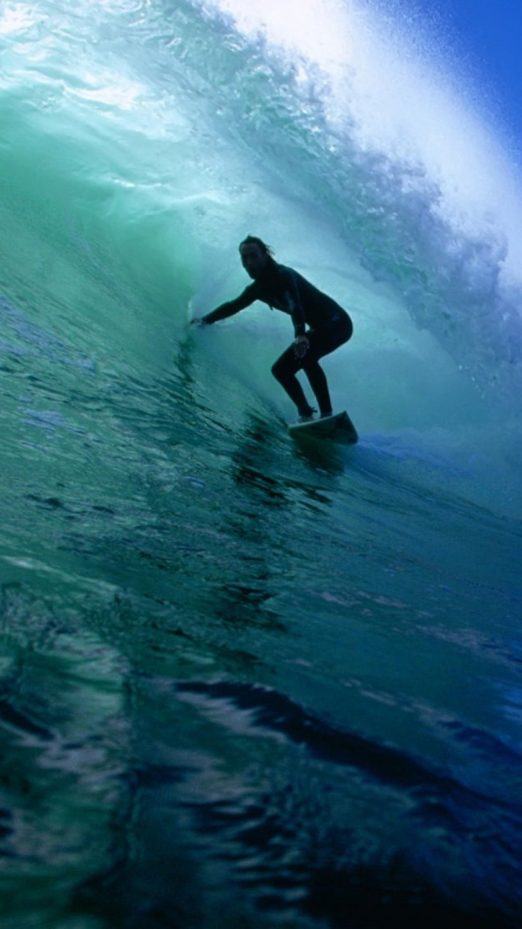 Man Surfing on Sea Waves During Daytime. Wallpaper in 750x1334 Resolution