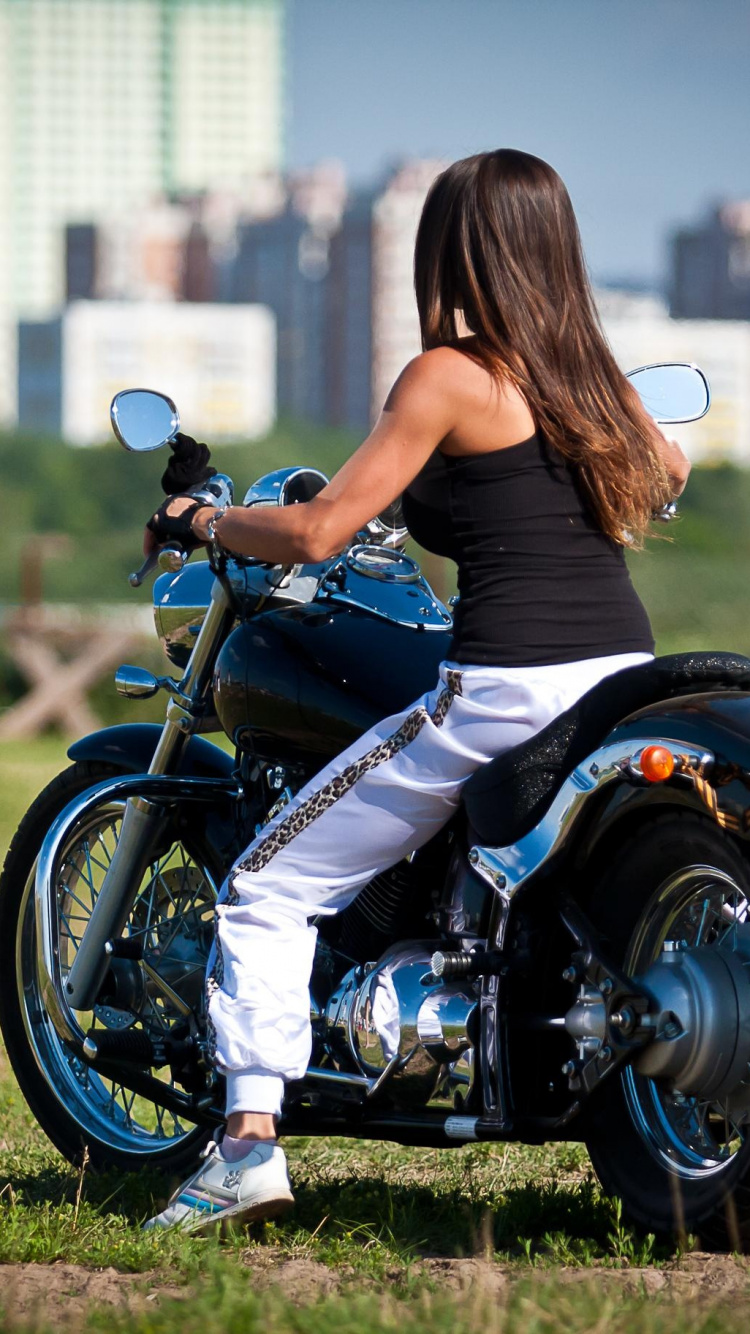 Woman in Blue Tank Top Riding on Black and White Motorcycle During Daytime. Wallpaper in 750x1334 Resolution