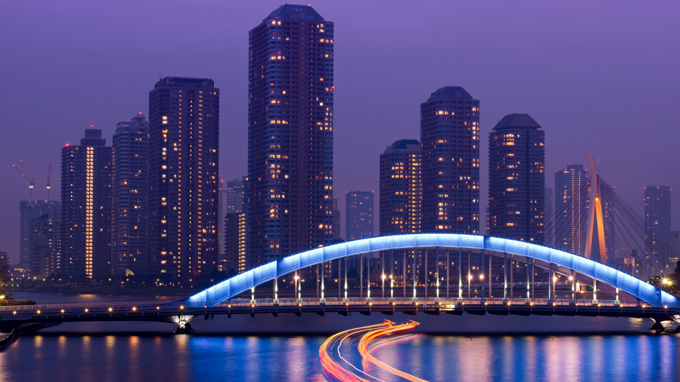 Lighted Bridge Over River Near High Rise Buildings During Night Time. Wallpaper in 1366x768 Resolution