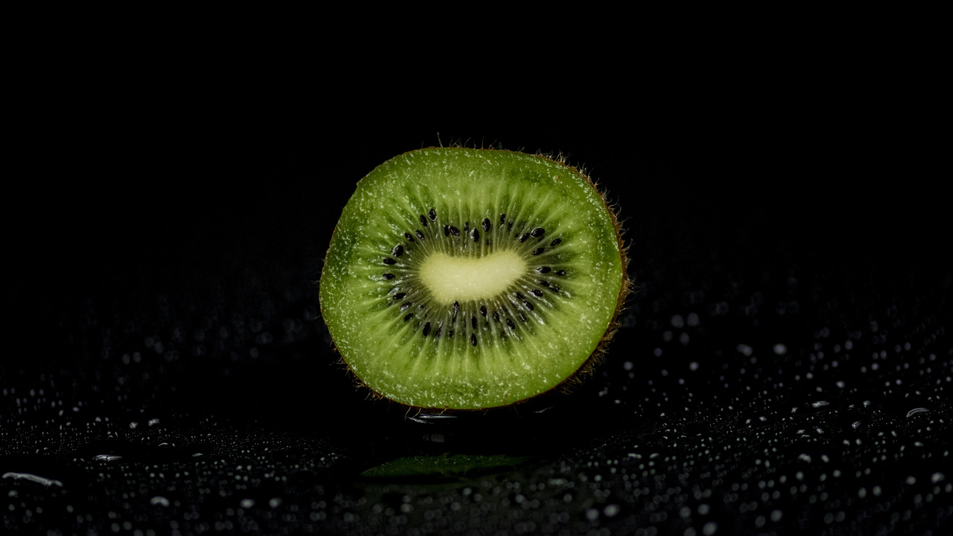 Green Round Fruit on Black Surface. Wallpaper in 1366x768 Resolution