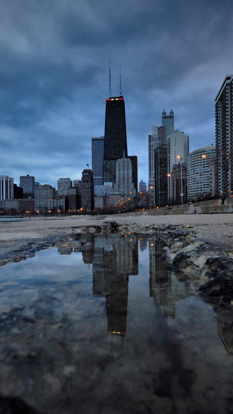 City Skyline Across The Sea During Daytime. Wallpaper in 750x1334 Resolution