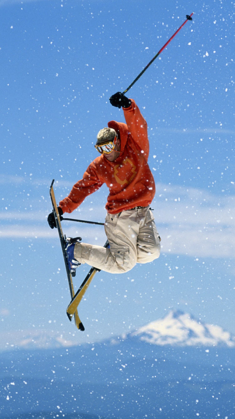 Man in Red Jacket and White Pants Riding Ski Blades on Snow Covered Ground During Daytime. Wallpaper in 750x1334 Resolution
