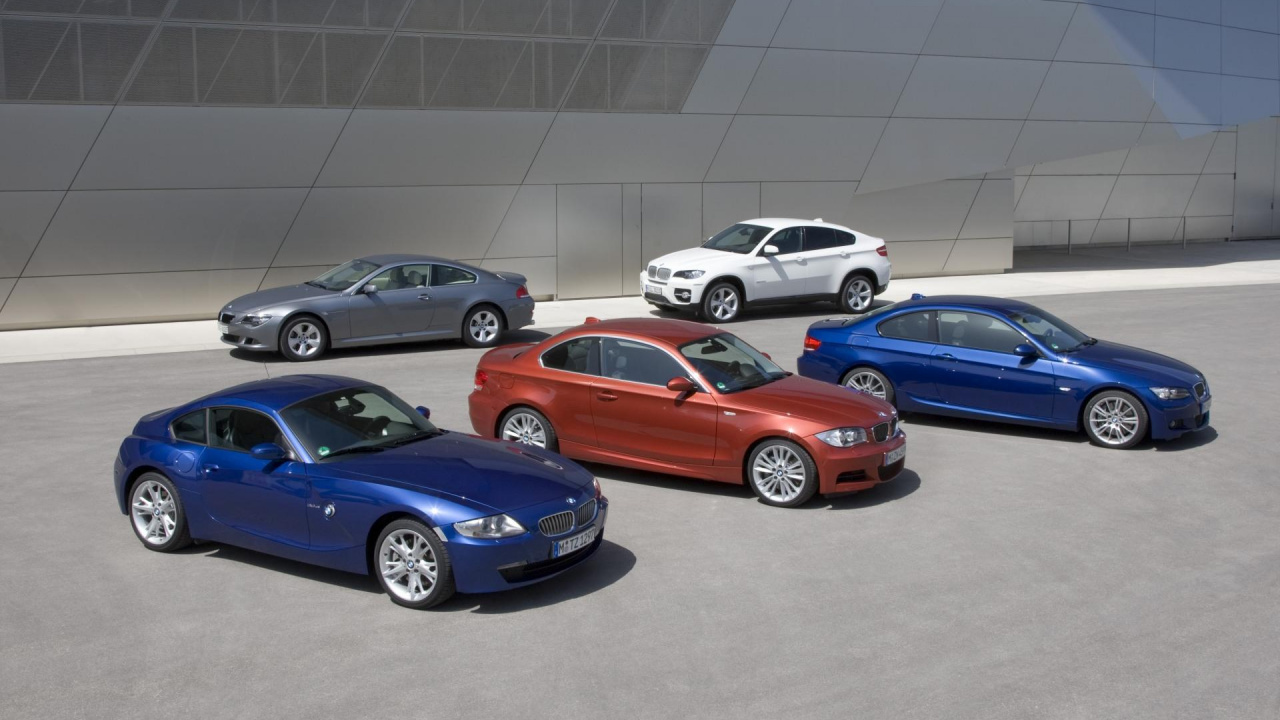 Blue Bmw Coupe Parked Beside White Sedan. Wallpaper in 1280x720 Resolution