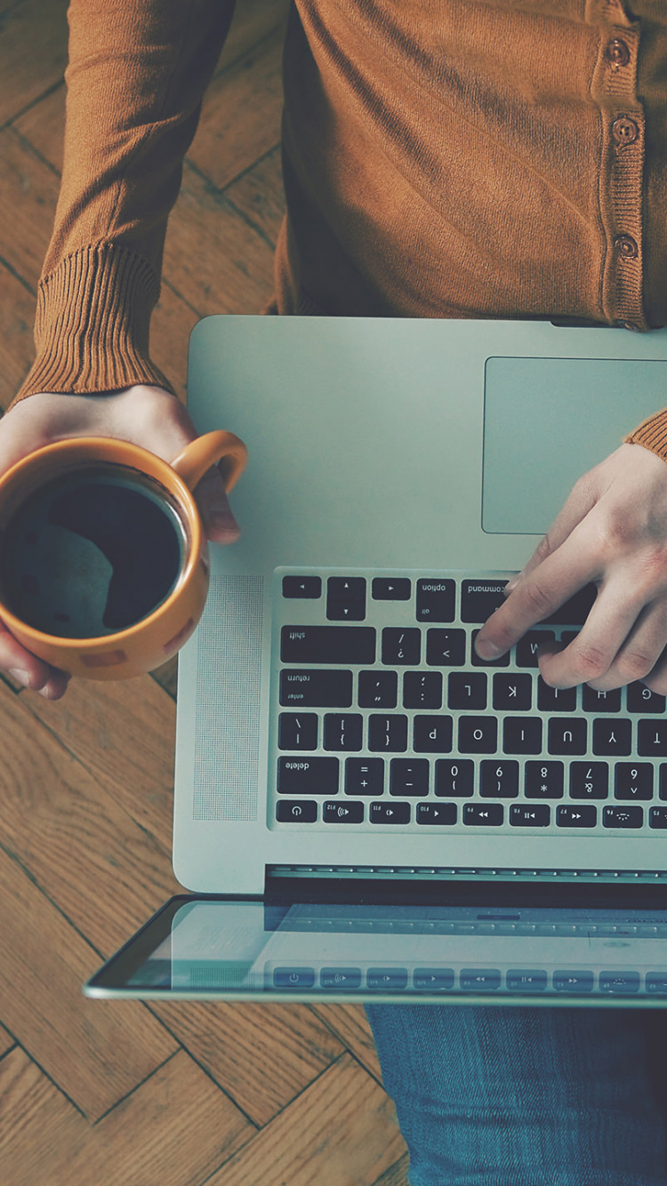 Person in Brown Long Sleeve Shirt Using Macbook Pro. Wallpaper in 750x1334 Resolution