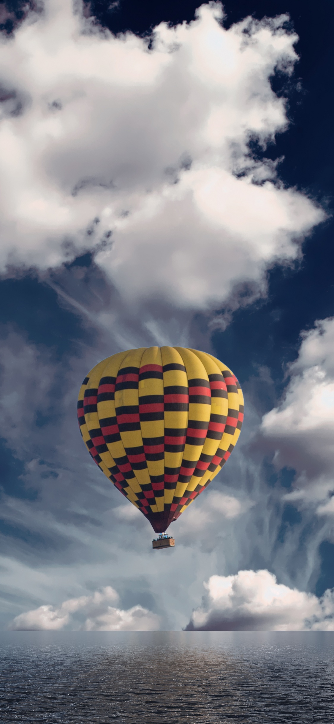 Yellow and Green Hot Air Balloon in Mid Air Under Blue and White Cloudy Sky During. Wallpaper in 1125x2436 Resolution
