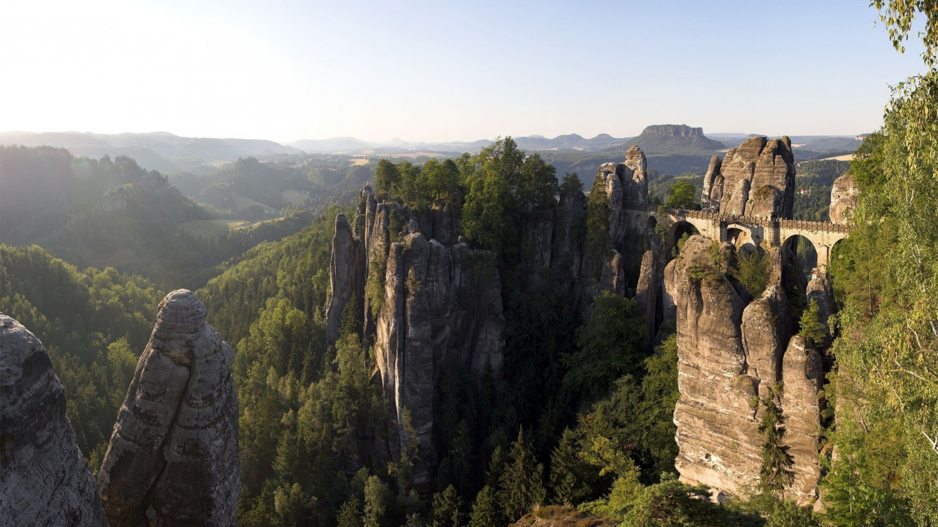 Green Trees on Brown Rocky Mountain During Daytime. Wallpaper in 1366x768 Resolution