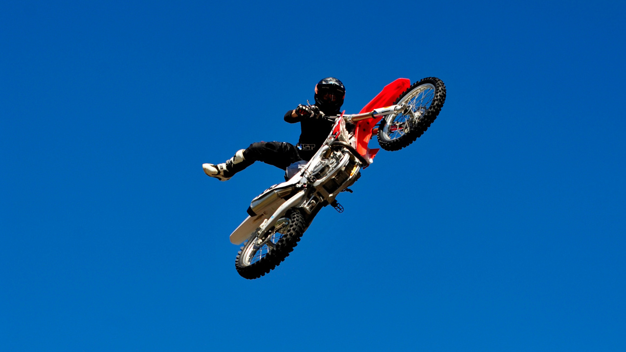 Man in Red and Black Motocross Suit Riding Red and White Motocross Dirt Bike. Wallpaper in 1280x720 Resolution