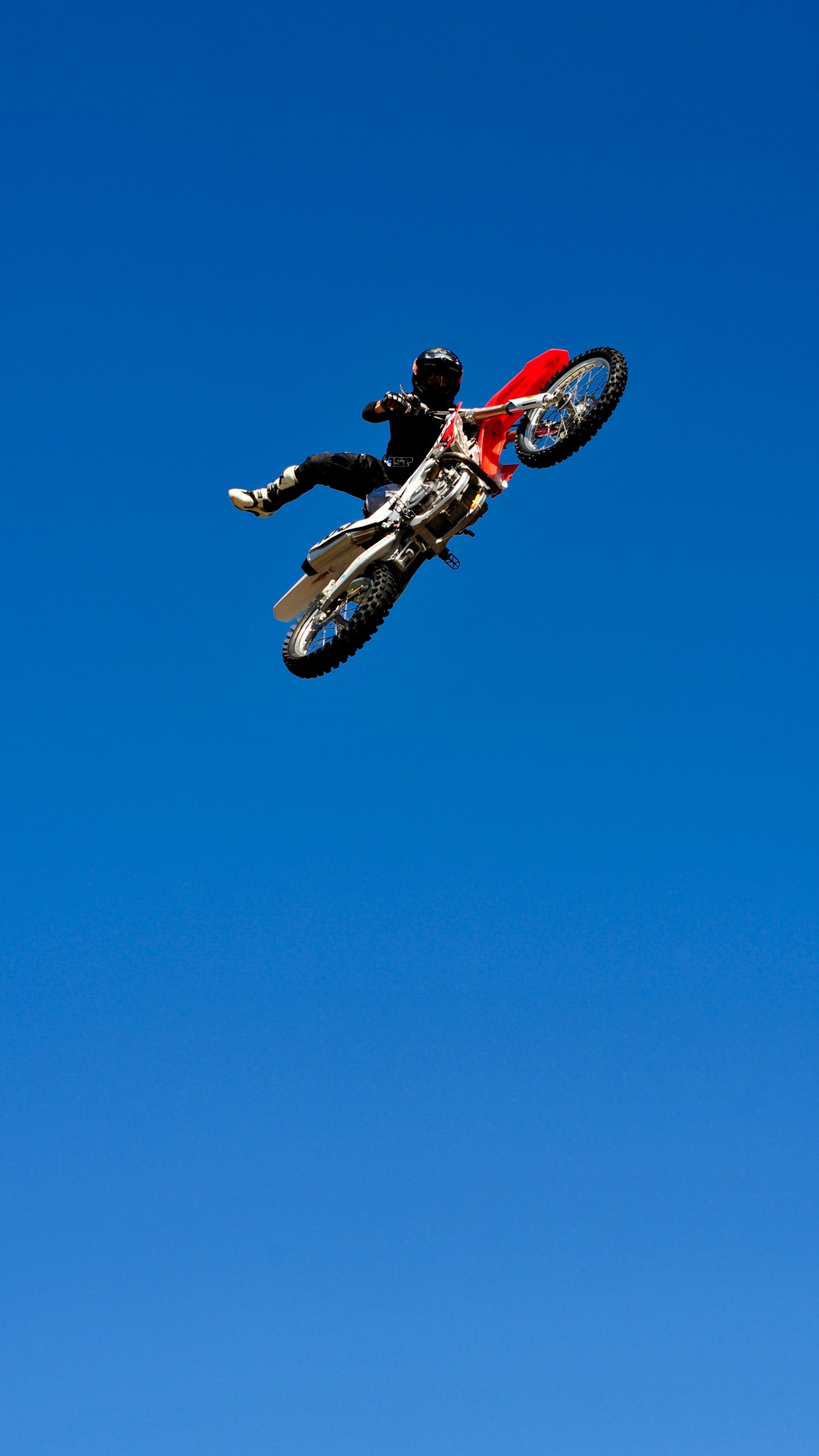 Man in Red and Black Motocross Suit Riding Red and White Motocross Dirt Bike. Wallpaper in 1440x2560 Resolution