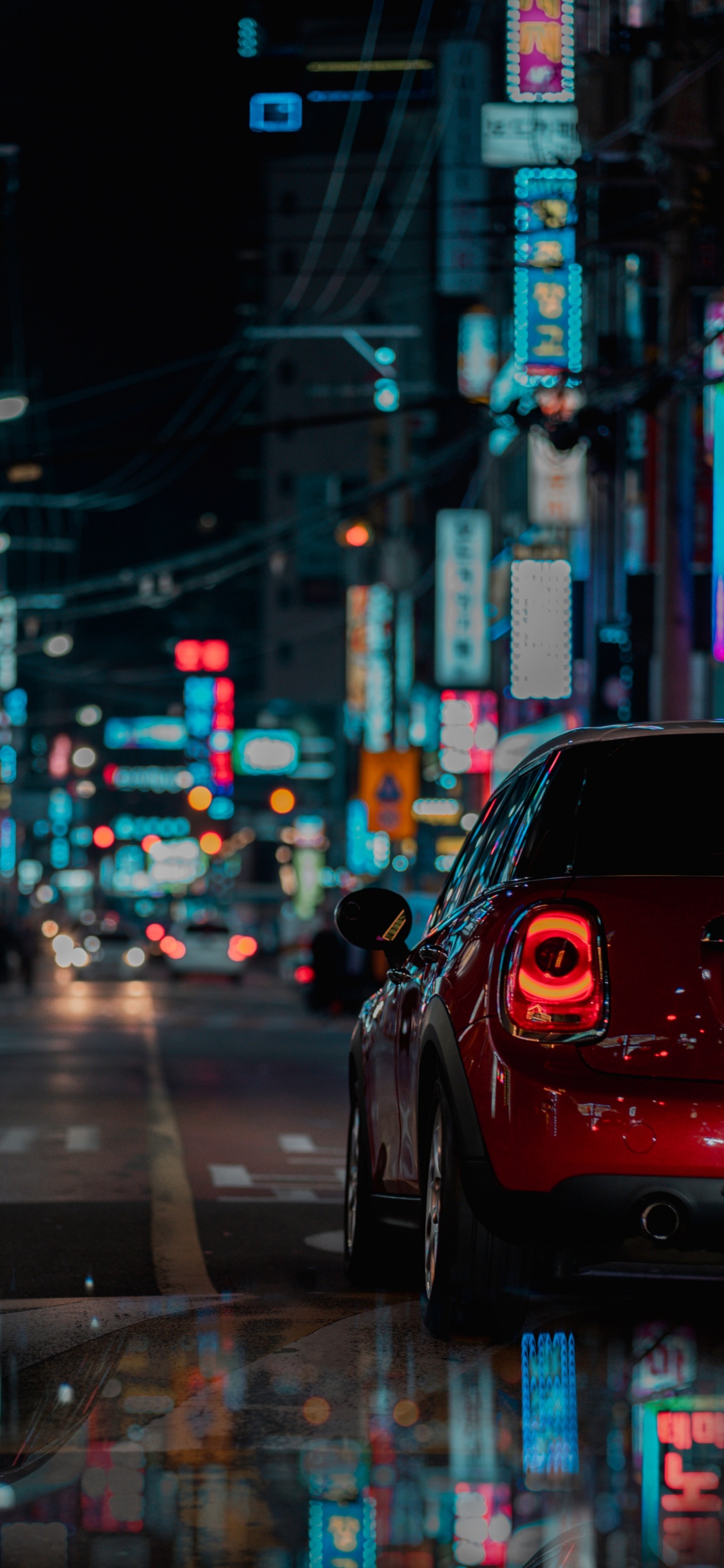 Black Car on Road During Night Time. Wallpaper in 1125x2436 Resolution