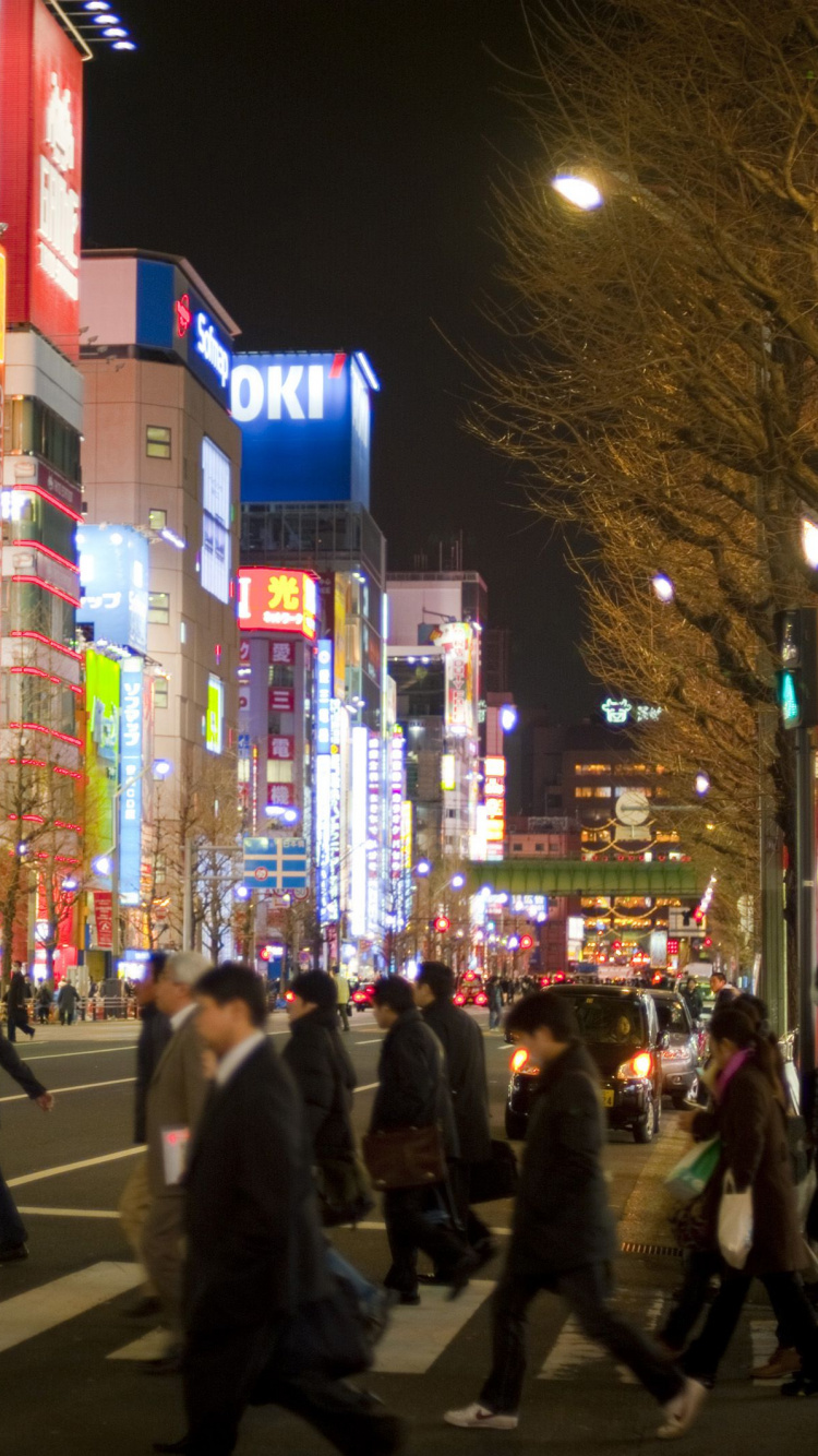 People Walking on Street During Night Time. Wallpaper in 750x1334 Resolution