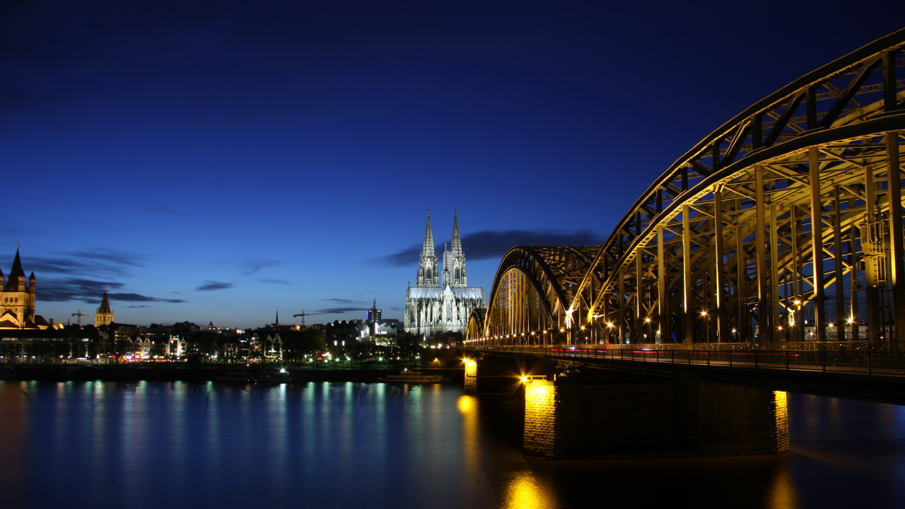 Lighted Bridge Over Water During Night Time. Wallpaper in 1280x720 Resolution