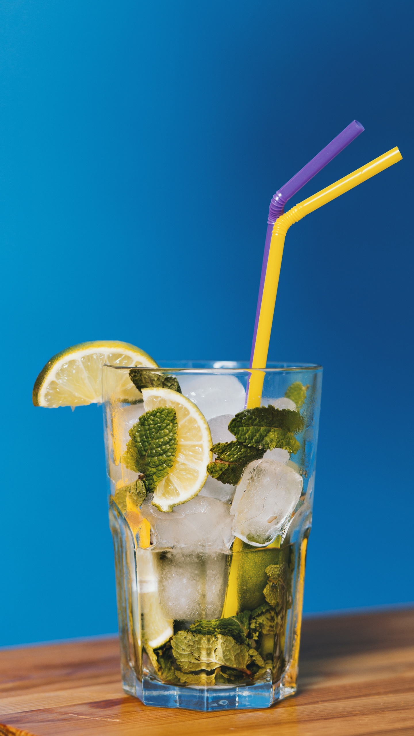 Clear Drinking Glass With Ice and Straw. Wallpaper in 1440x2560 Resolution