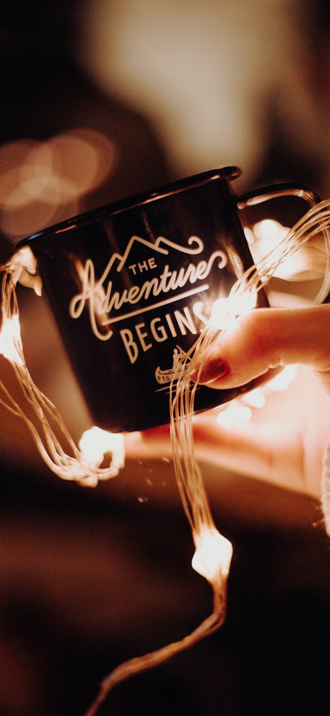 Person Holding Black and White Ceramic Mug. Wallpaper in 1125x2436 Resolution