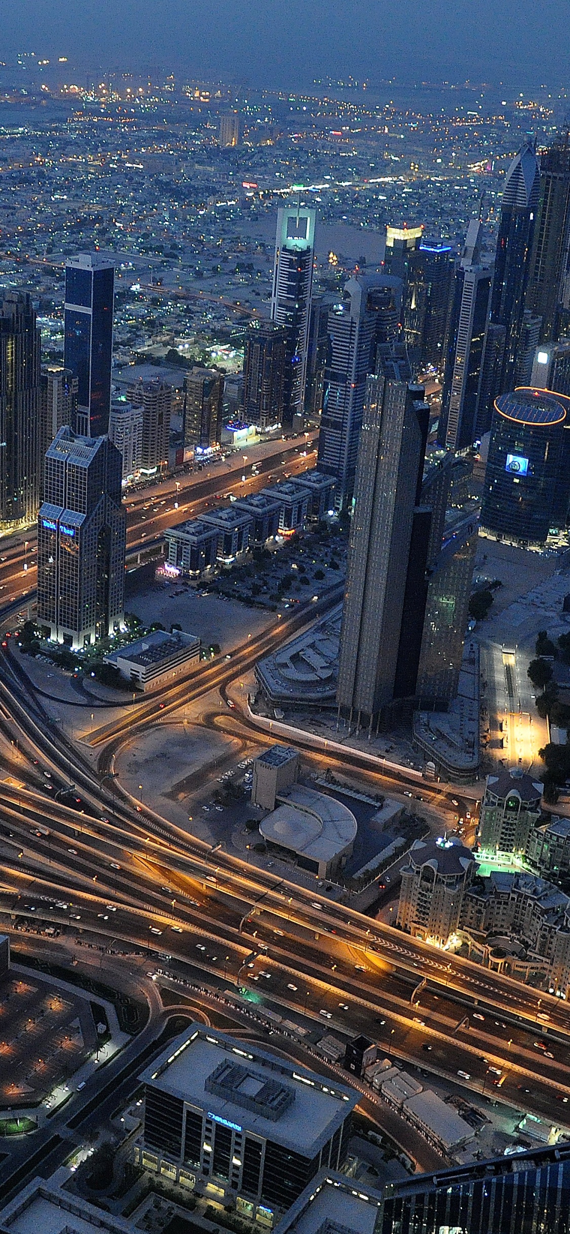 Aerial View of City Buildings During Night Time. Wallpaper in 1125x2436 Resolution