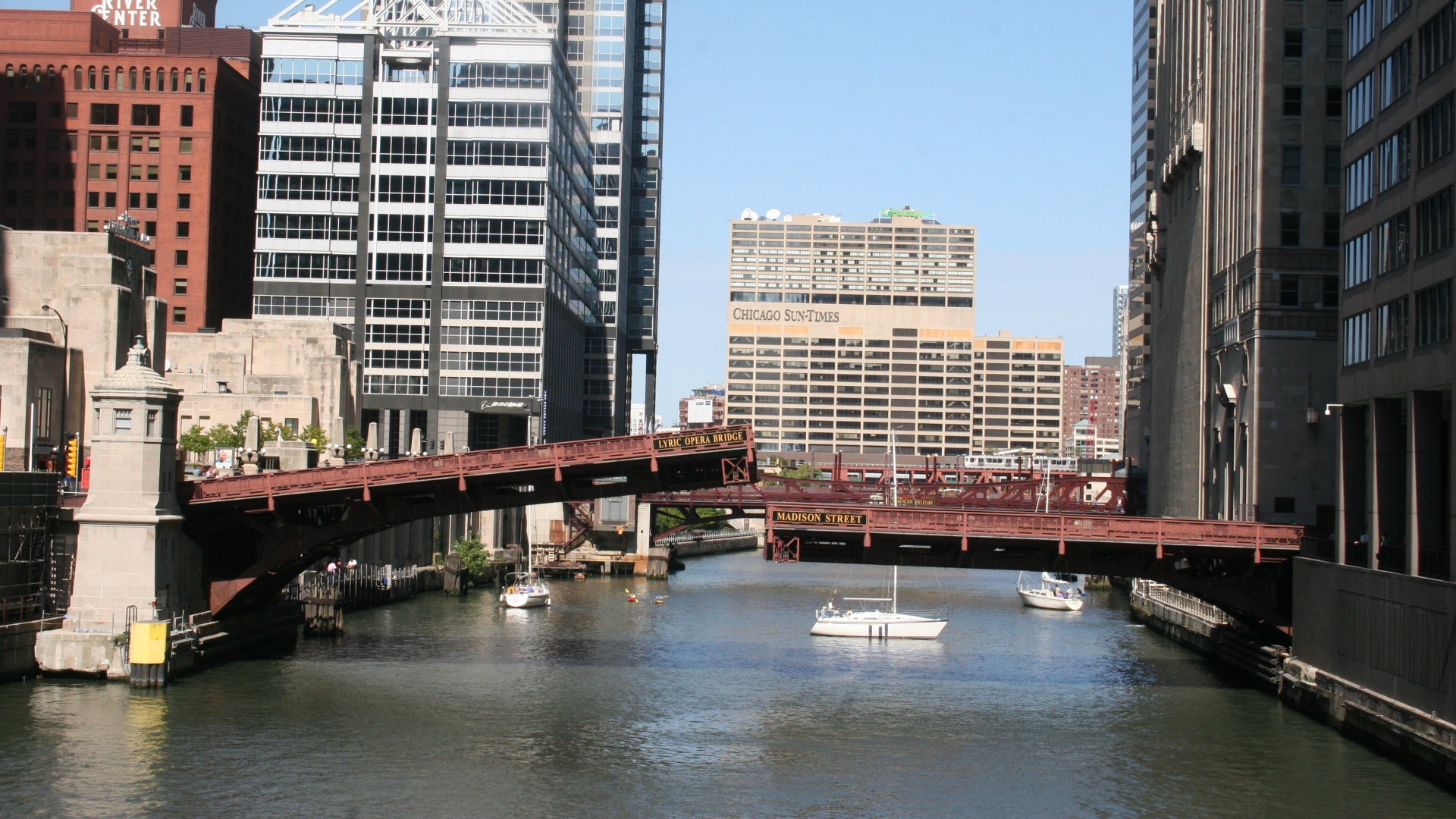 Brown Bridge Over River Near High Rise Buildings During Daytime. Wallpaper in 1920x1080 Resolution