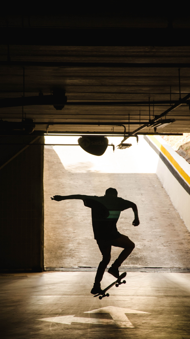 Man in Black Shirt and Black Pants Jumping on Air. Wallpaper in 750x1334 Resolution