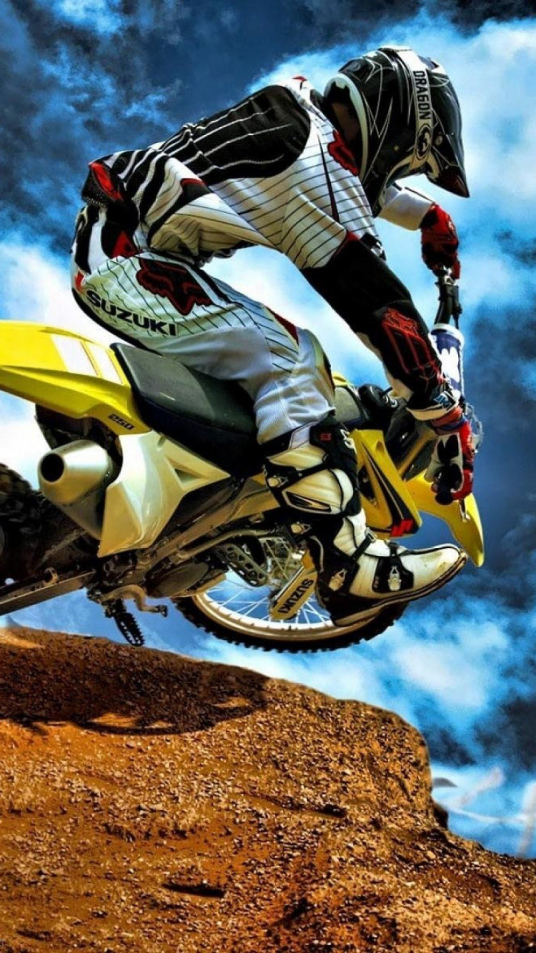 Man Riding Motocross Dirt Bike. Wallpaper in 750x1334 Resolution
