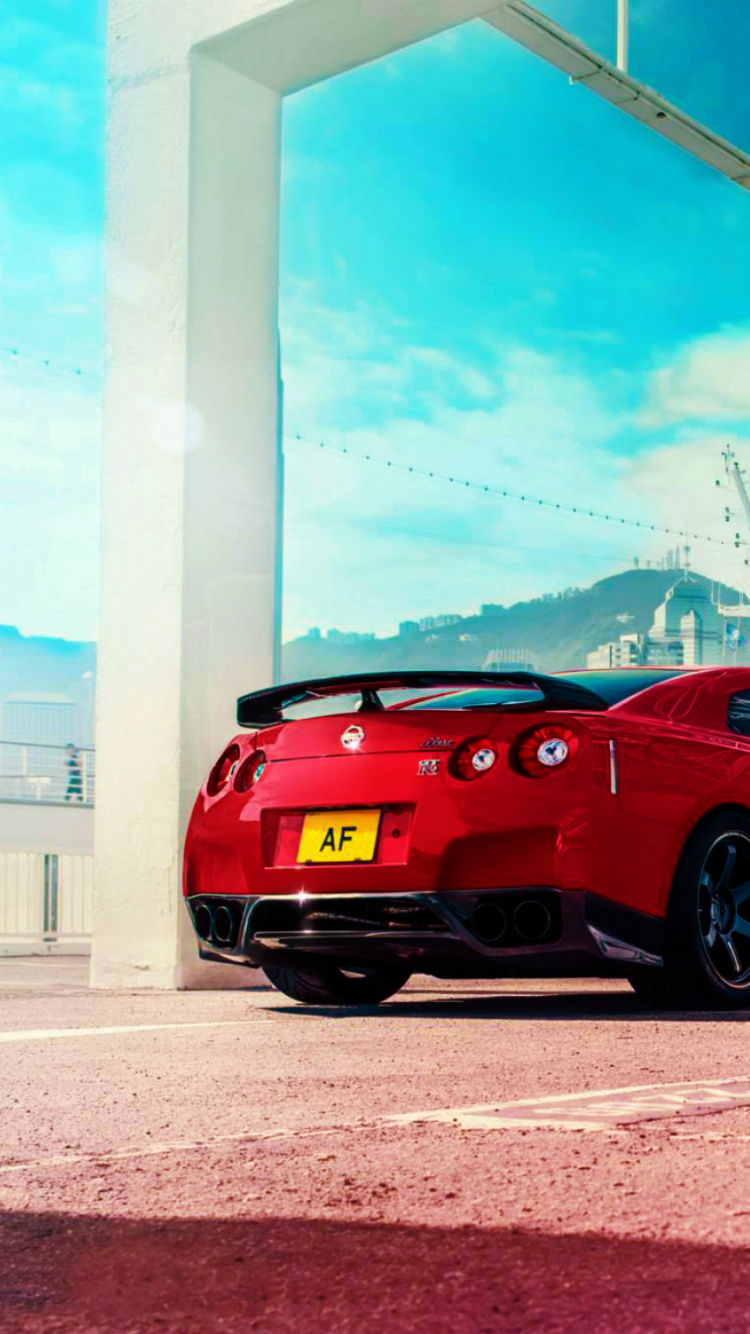 Red Ferrari 458 Italia Parked Near White Building. Wallpaper in 750x1334 Resolution