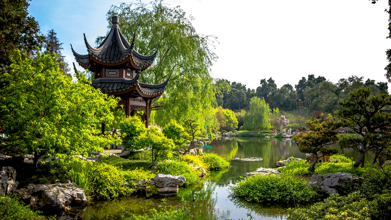 Brown and Black Pagoda Temple Near Lake Surrounded by Green Trees During Daytime. Wallpaper in 1280x720 Resolution