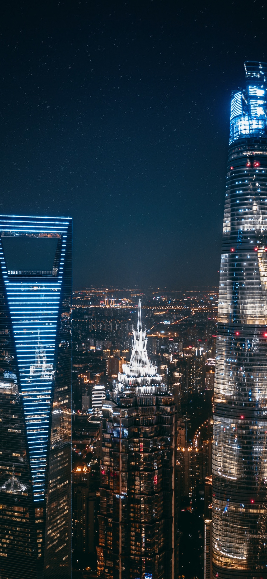 City Skyline During Night Time. Wallpaper in 1125x2436 Resolution