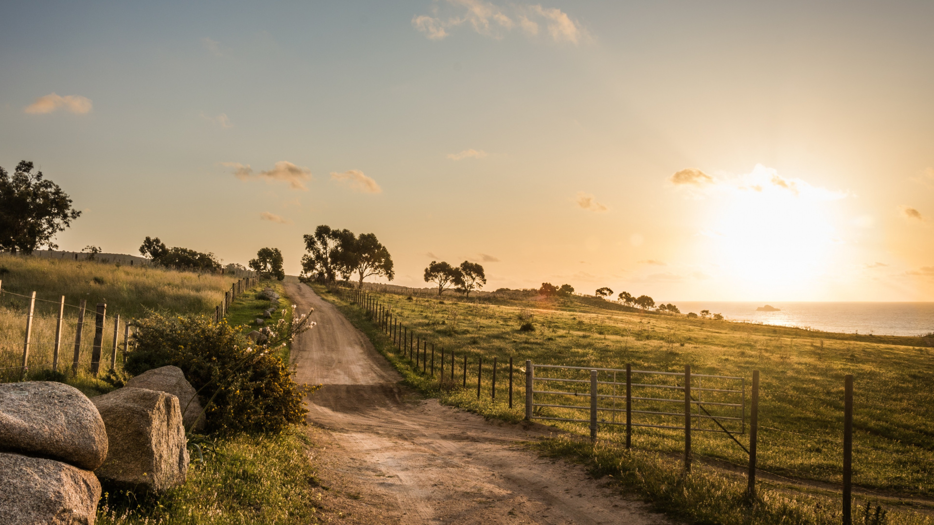 Gray Dirt Road Between Green Grass Field Under White Clouds During Daytime. Wallpaper in 1920x1080 Resolution