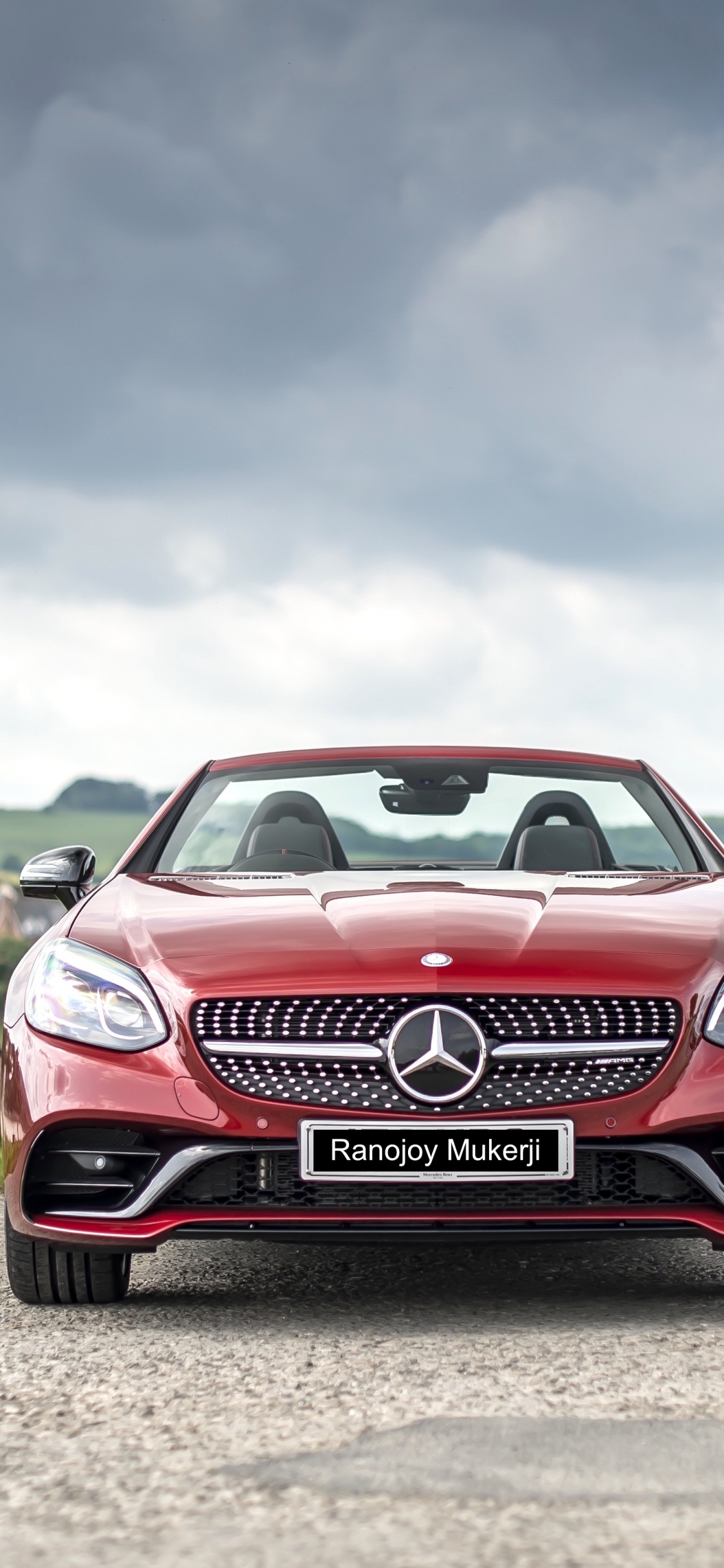Red and White Bmw m 3 on Green Grass Field Under White Clouds and Blue Sky. Wallpaper in 1125x2436 Resolution