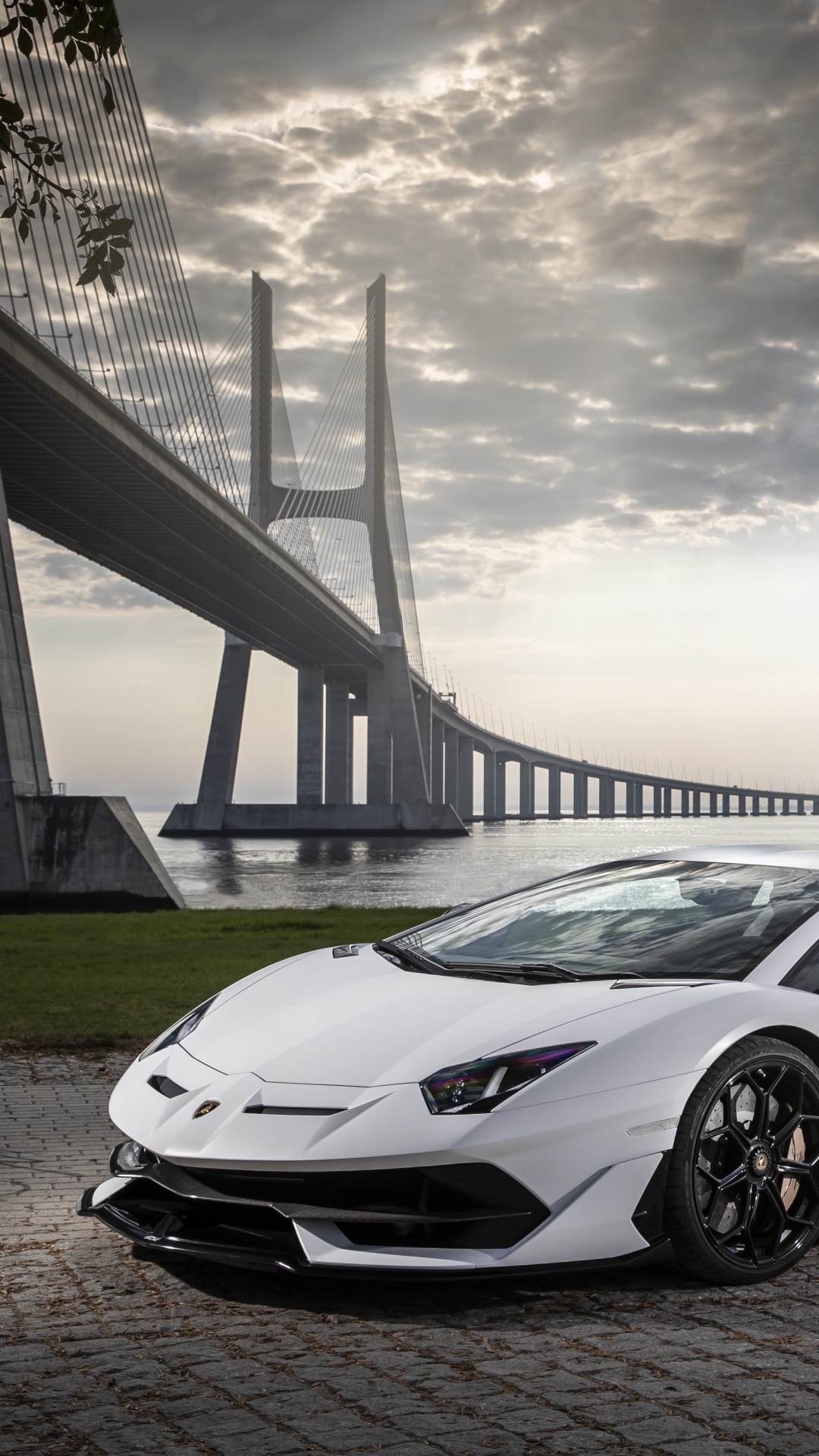White Porsche 911 on Gray Concrete Road Under Gray Clouds. Wallpaper in 1080x1920 Resolution