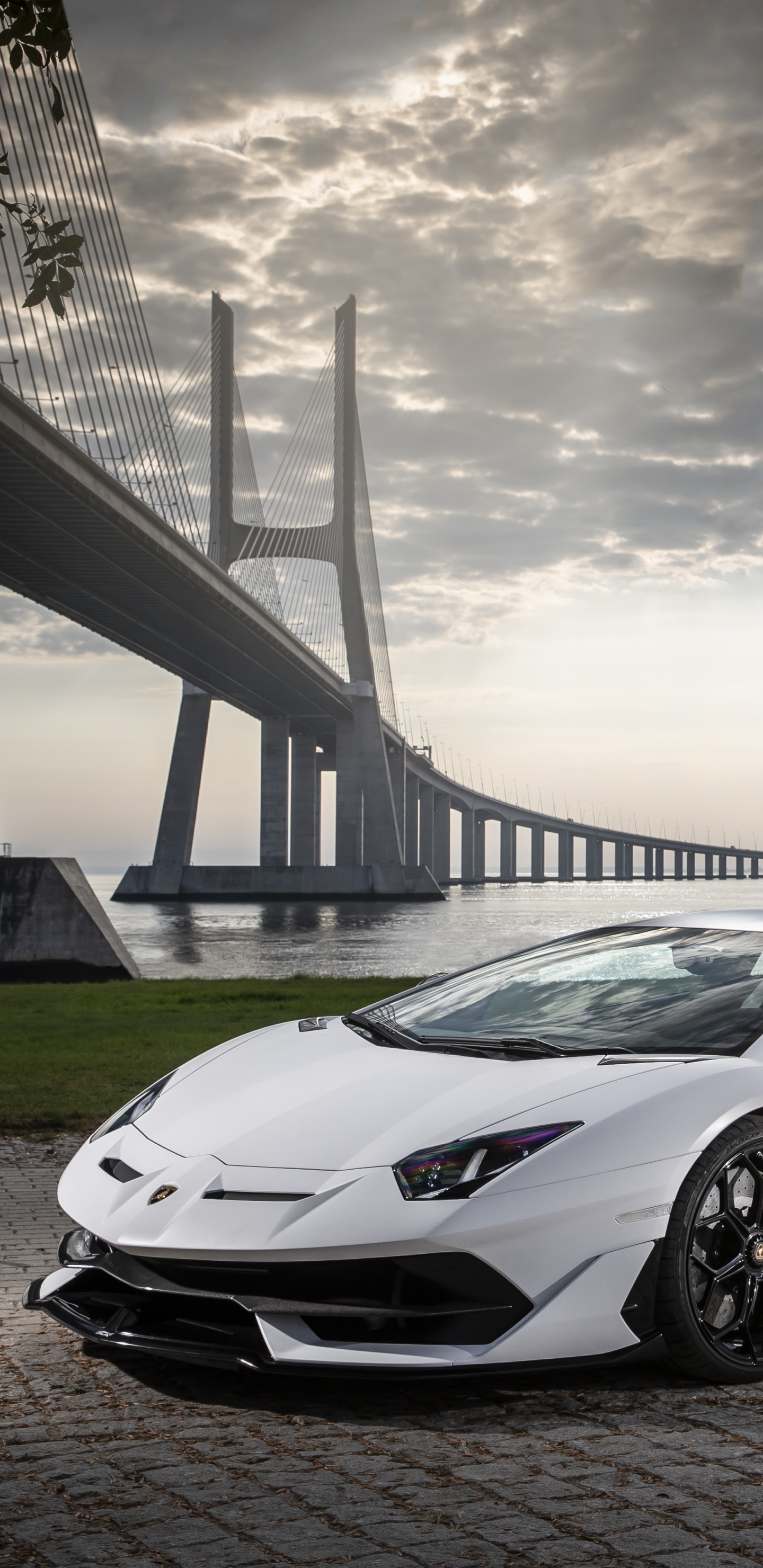 White Porsche 911 on Gray Concrete Road Under Gray Clouds. Wallpaper in 1440x2960 Resolution