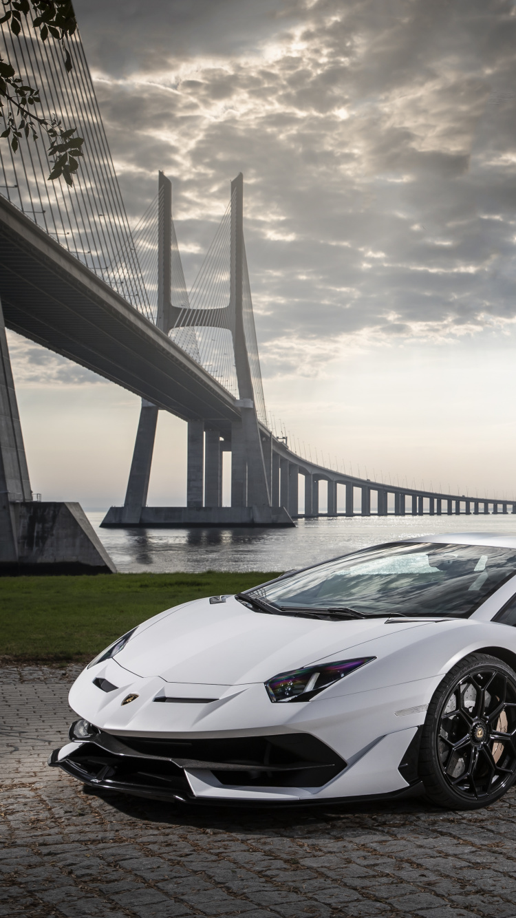 White Porsche 911 on Gray Concrete Road Under Gray Clouds. Wallpaper in 750x1334 Resolution