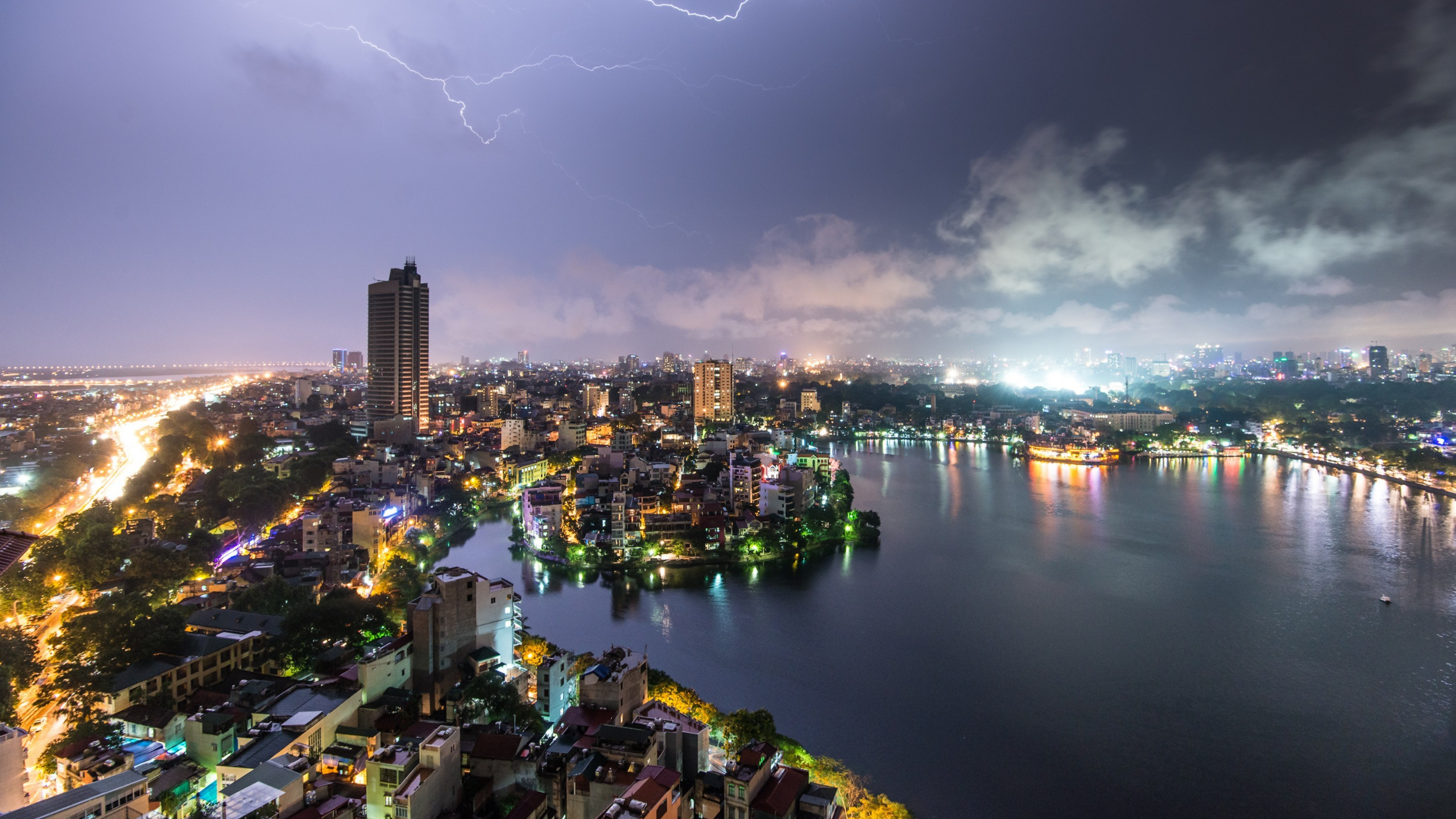 City Skyline With Lightning Above During Night Time. Wallpaper in 2560x1440 Resolution