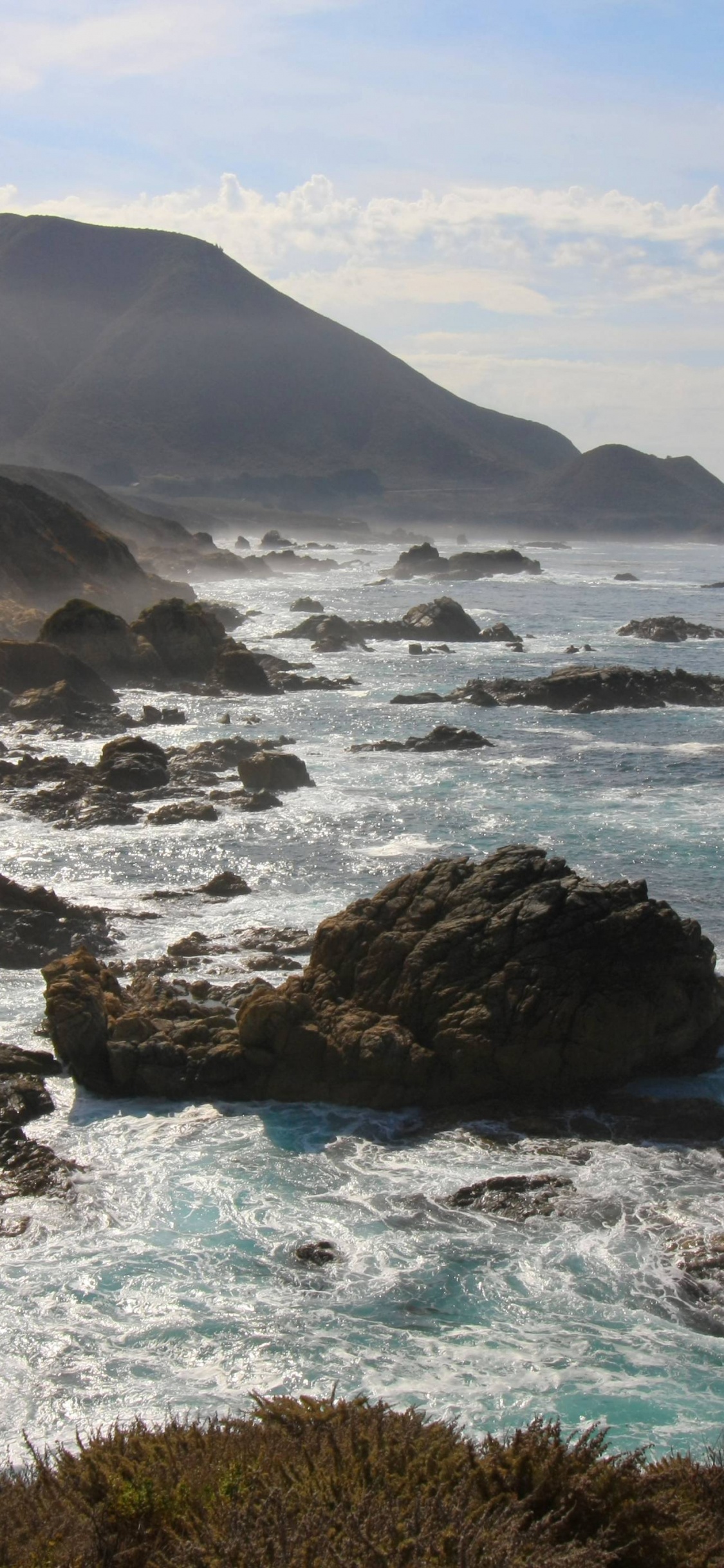 Black Rock Formation on Sea During Daytime. Wallpaper in 1125x2436 Resolution