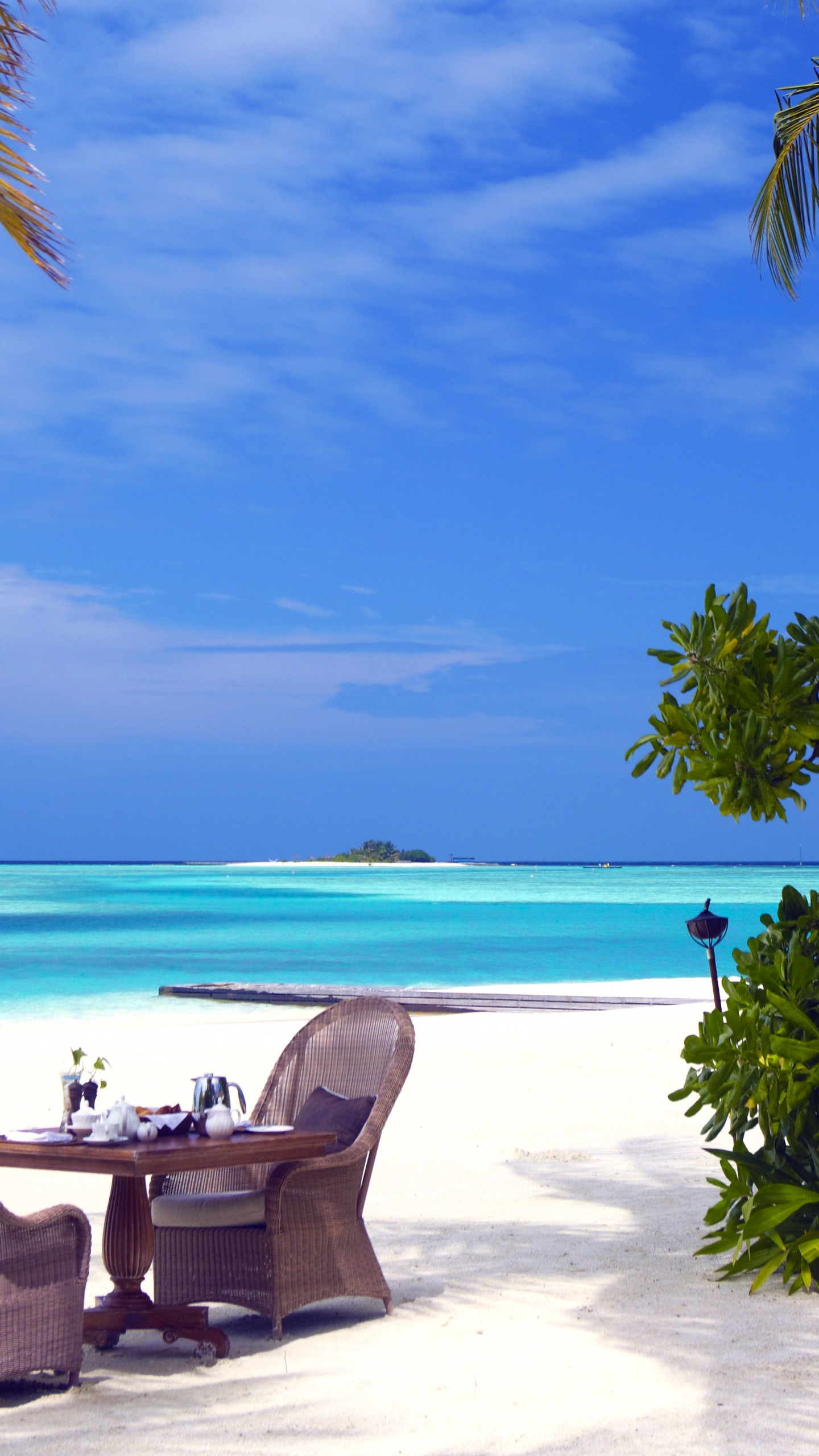 Brown Wooden Outdoor Lounge Chairs on Beach During Daytime. Wallpaper in 1440x2560 Resolution