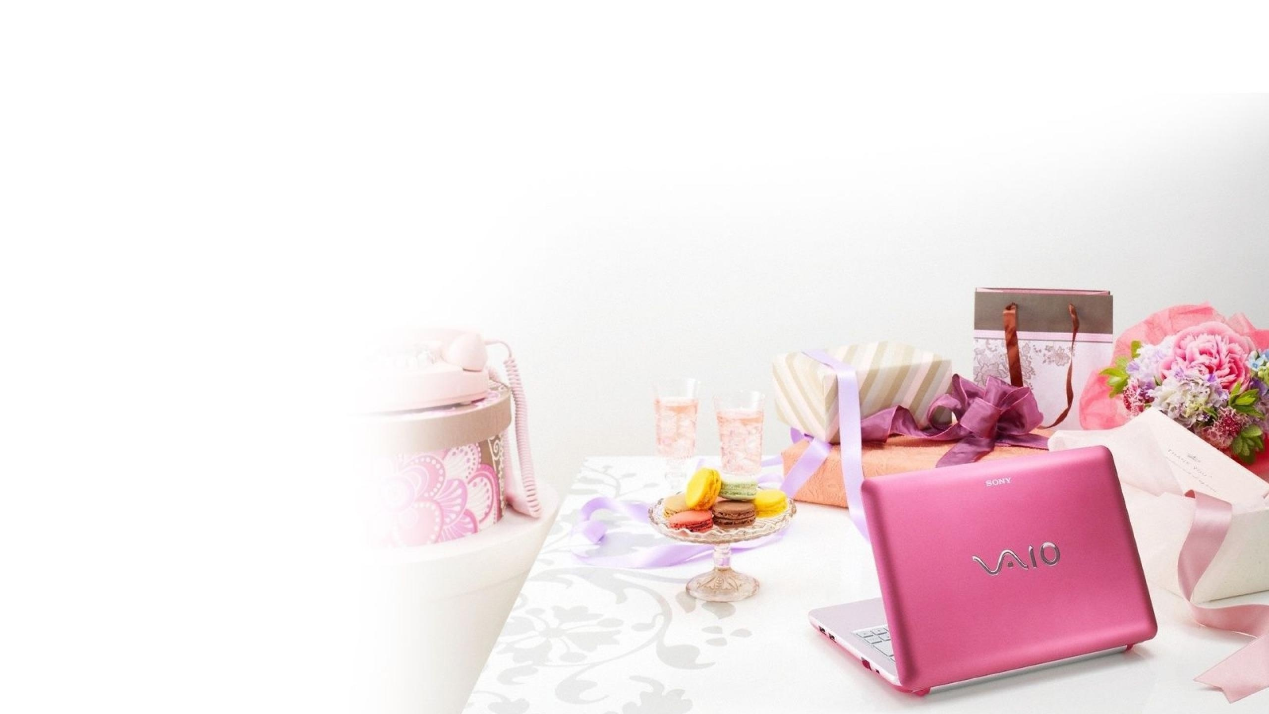 Pink Laptop Computer on Table. Wallpaper in 2560x1440 Resolution