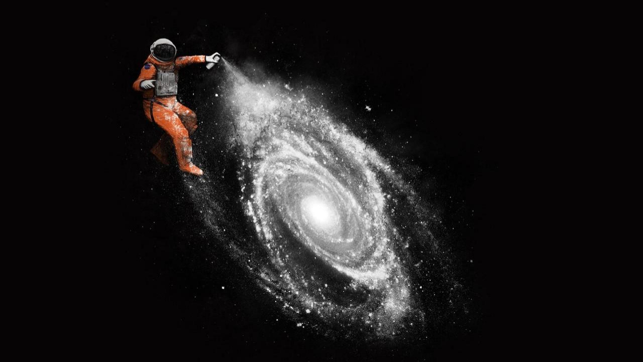 Man in Orange Jacket and Black Pants Standing on Black and White Galaxy. Wallpaper in 1280x720 Resolution